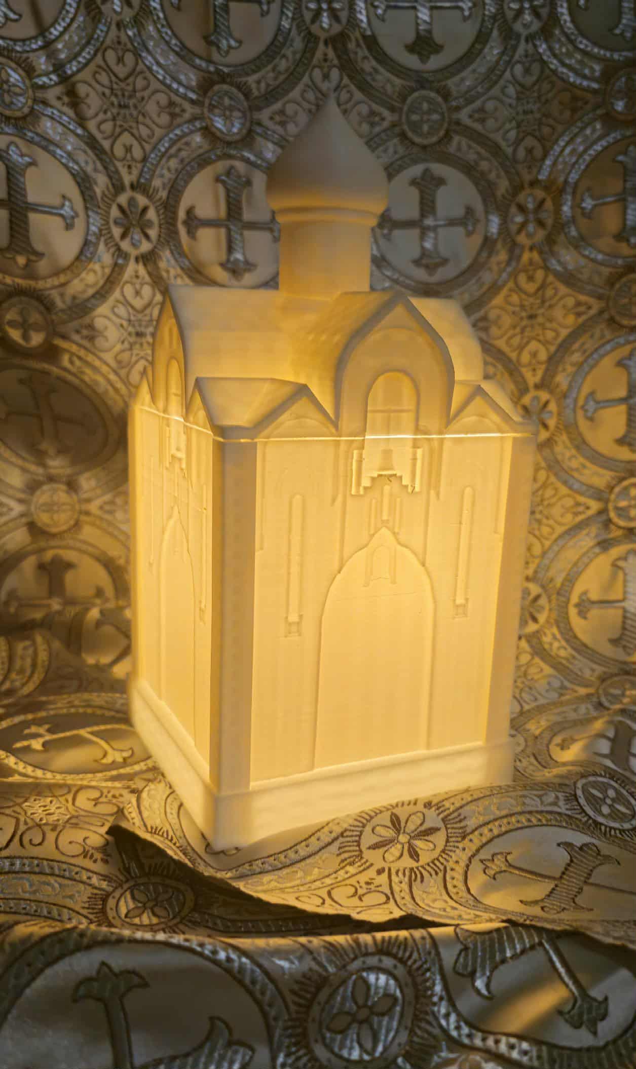 Glowing lantern with mosque-like architecture against ornate patterned background